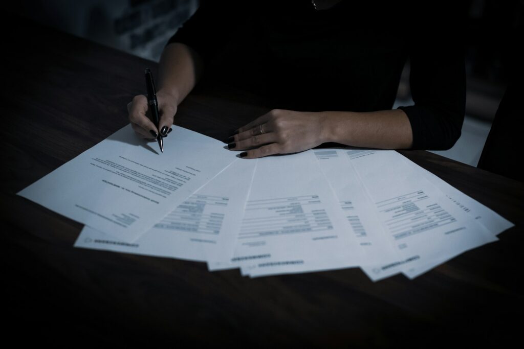 Small business owner reviewing compliance paperwork at a table, a common task for Fuquay-Varina and Harnett County businesses