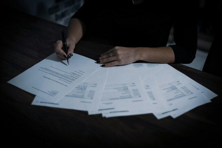 Small business owner reviewing compliance paperwork at a table, a common task for Fuquay-Varina and Harnett County businesses